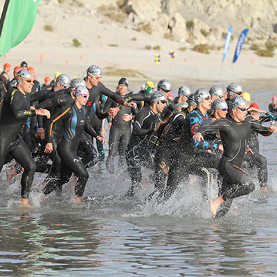 Triathletes entering water at Lake Cahuilla