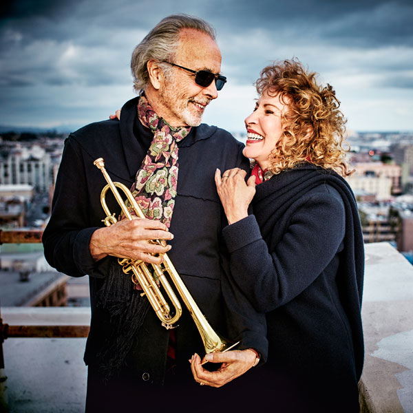 Herb Albert holding trumpet with Lani Hall