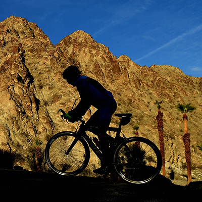Bicyclist silhouette in front of desert mountains