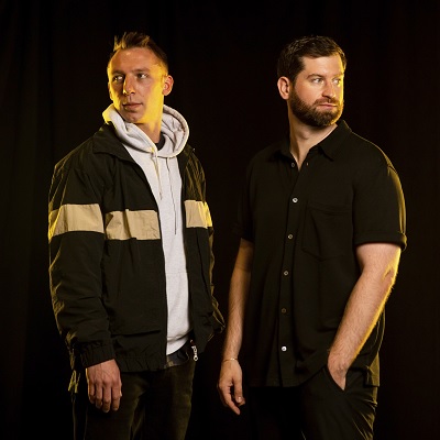 The group known as Odesza standing together