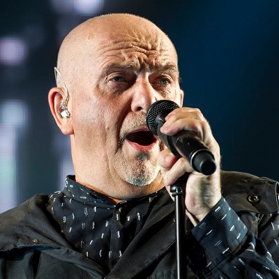 Peter Gabriel Singing into a Microphone