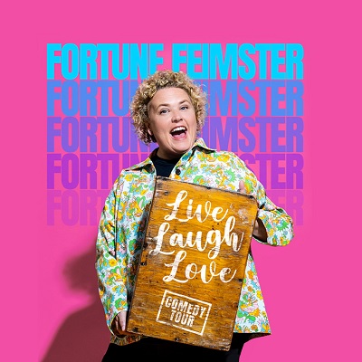 Fortune Feimster holding a live laugh love sign