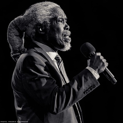 Billy Ocean holding a microphone in a black and white picture