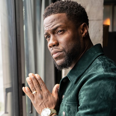 Kevin Hart by a window with his hands together