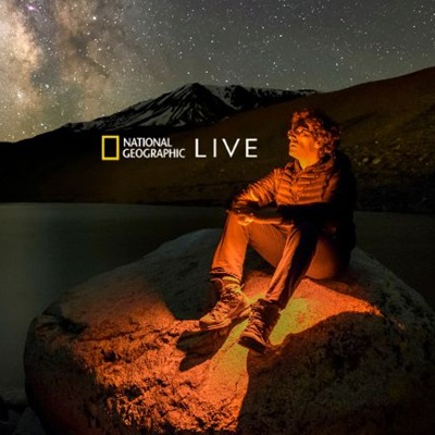 Jeffrey sitting on a rock at night