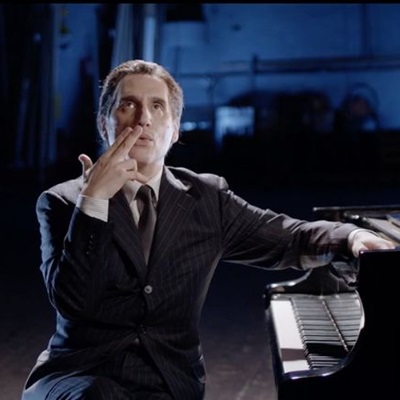 george gershwin sitting at a piano