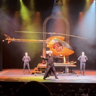 illusionist rick thomas in front of a helicopter