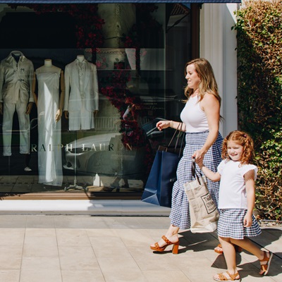 mother and daughter walking down El Paseo