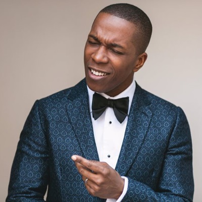 leslie odom jr on a beige background